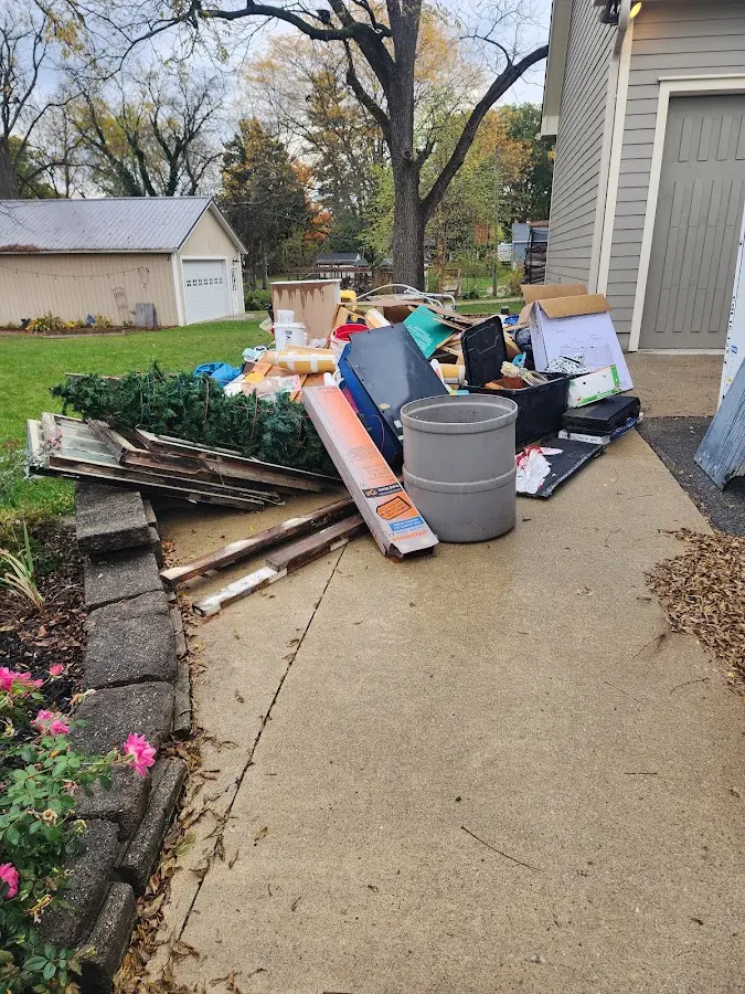 Dumpster being loaded with debris for Roofing Dumpster Rental in Wolfeboro